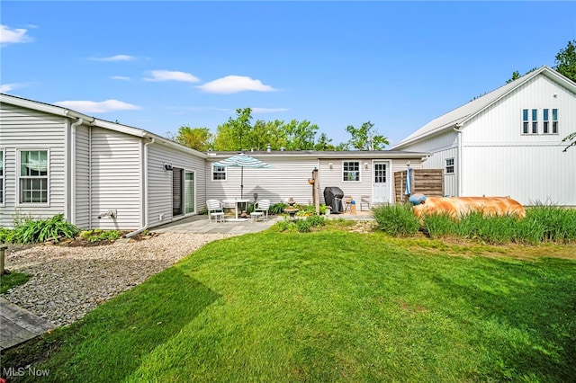 7214 Ridge Ave, Conneaut, OH 44030 - rear view of property featuring a patio and a lawn