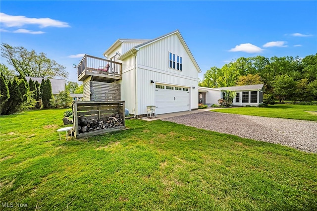 7214 Ridge Ave, Conneaut, OH 44030 - view of side of property featuring gravel driveway, a garage, a yard, and board and batten siding