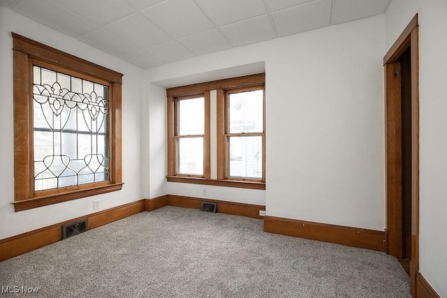 3615 Spokane Ave, Cleveland, OH 44109 - empty room with healthy amount of natural light, carpet floors, baseboards, and a drop ceiling