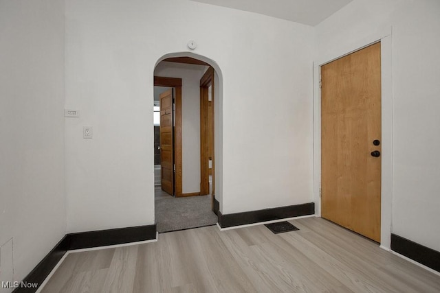 3615 Spokane Ave, Cleveland, OH 44109 - unfurnished room featuring wood finished floors, arched walkways, and baseboards