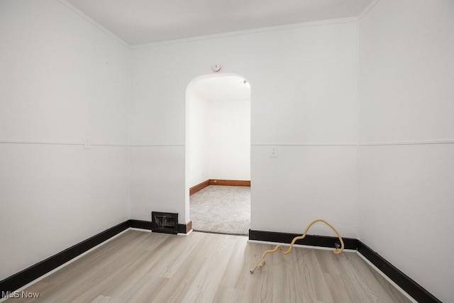 3615 Spokane Ave, Cleveland, OH 44109 - empty room featuring wood finished floors, crown molding, baseboards, and arched walkways