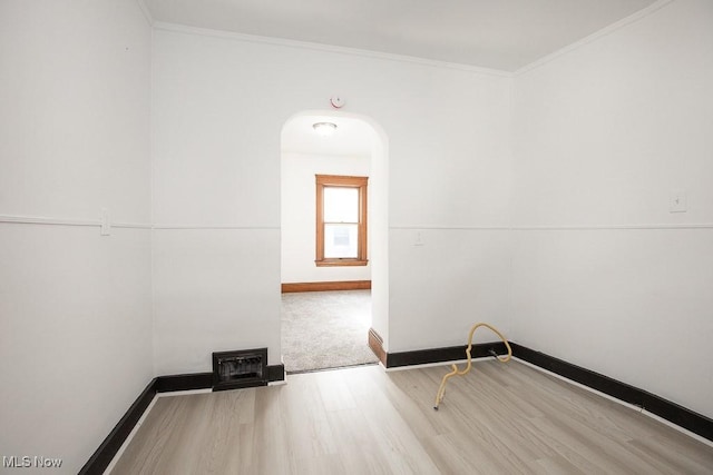 3615 Spokane Ave, Cleveland, OH 44109 - empty room with wood finished floors, crown molding, baseboards, and arched walkways