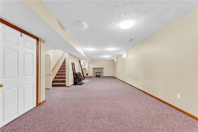 2736 Green Rd, Shaker Heights, OH 44122 - finished below grade area featuring baseboards, a brick fireplace, a textured ceiling, and carpet