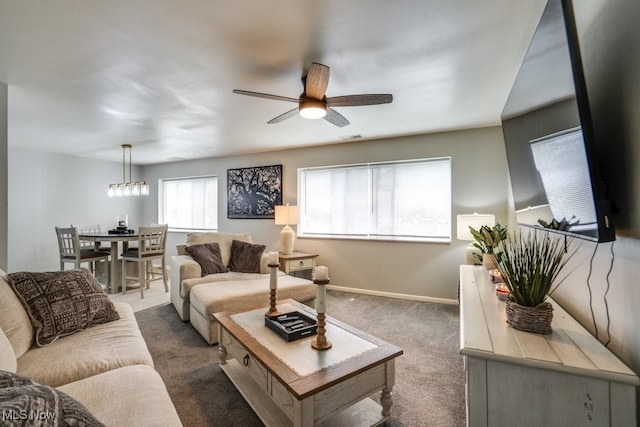 living area with ceiling fan, dark colored carpet, and baseboards