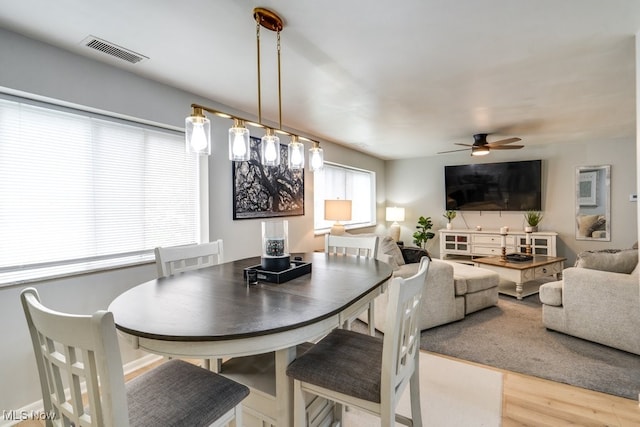 dining area featuring a ceiling fan and wood finished floors
