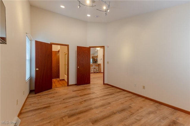 6957 Tippecanoe Rd, Canfield, OH 44406 - spare room with light wood-type flooring, a towering ceiling, baseboards, and recessed lighting