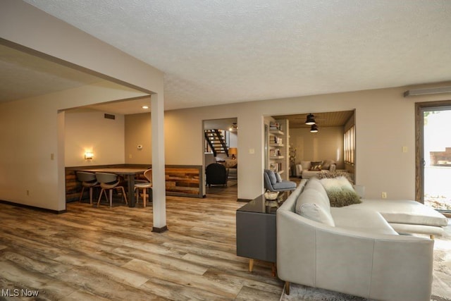 1367 Mockingbird Dr, Kent, OH 44240 - living area with stairs, wood finished floors, and a textured ceiling