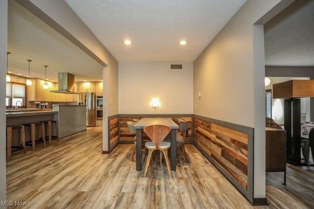 1367 Mockingbird Dr, Kent, OH 44240 - dining space with light wood-style floors, a wainscoted wall, and recessed lighting