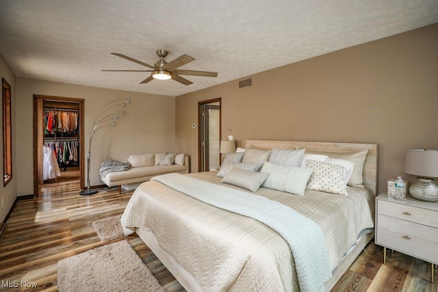 1367 Mockingbird Dr, Kent, OH 44240 - bedroom with wood finished floors, a closet, a spacious closet, ceiling fan, and a textured ceiling