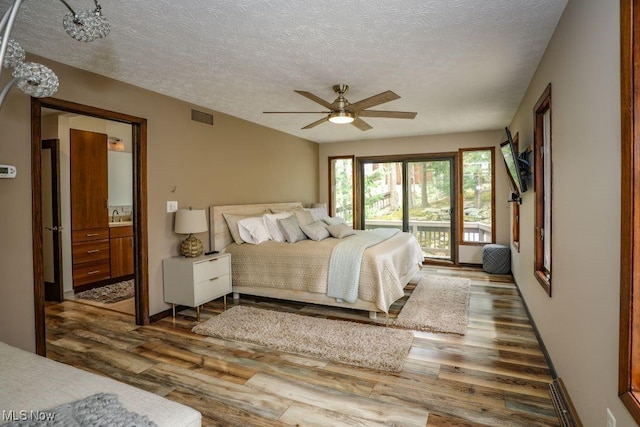 1367 Mockingbird Dr, Kent, OH 44240 - bedroom with wood finished floors, access to outside, a textured ceiling, connected bathroom, and a ceiling fan