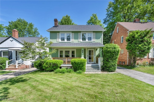 3403 Hartwood Rd, Cleveland Heights, OH 44112 - view of front of house featuring a front yard, a chimney, a porch, and roof with shingles
