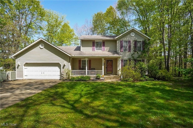 3277 Plainview Rd, Ravenna, OH 44266 - traditional home with a porch, a garage, asphalt driveway, and a front lawn