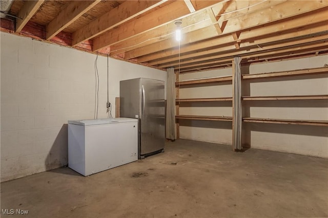 3277 Plainview Rd, Ravenna, OH 44266 - unfinished basement featuring fridge, freestanding refrigerator, and concrete block wall