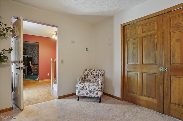 3277 Plainview Rd, Ravenna, OH 44266 - living area featuring light colored carpet, an upstairs landing, baseboards, and a textured ceiling
