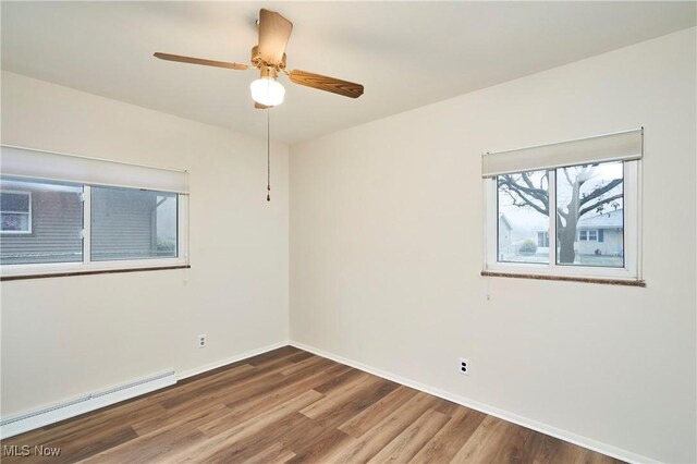 1658 Bronson Rd, Akron, OH 44305 - unfurnished room with a baseboard radiator, wood finished floors, a ceiling fan, and baseboards