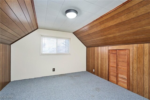 1658 Bronson Rd, Akron, OH 44305 - additional living space with carpet flooring, lofted ceiling, and wood walls