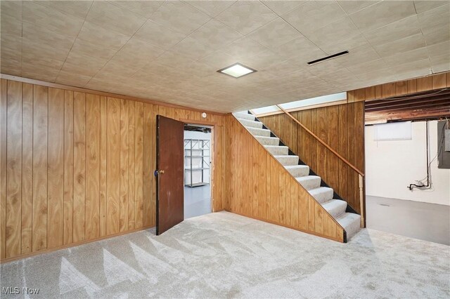 1658 Bronson Rd, Akron, OH 44305 - below grade area featuring carpet floors, wooden walls, and stairs
