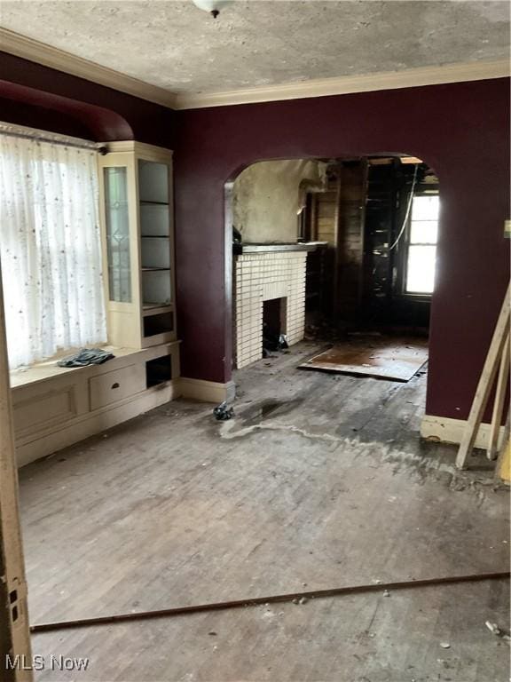 17205 Mapleboro Ave, Maple Heights, OH 44137 - unfurnished living room with a fireplace, arched walkways, and ornamental molding