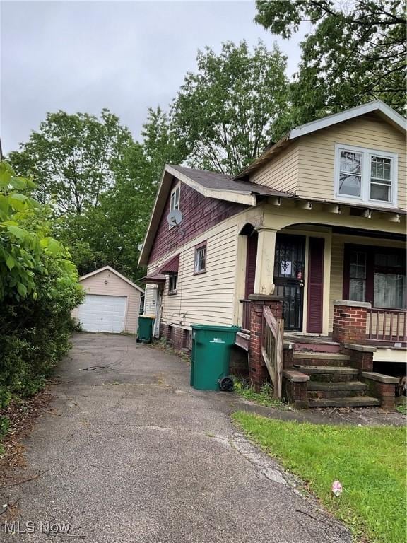 17205 Mapleboro Ave, Maple Heights, OH 44137 - bungalow-style home with a detached garage, a porch, and an outdoor structure