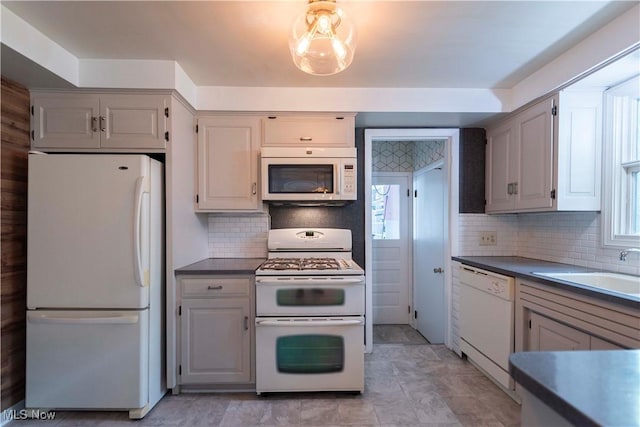338 Applegrove St NE, North Canton, OH 44720 - kitchen featuring white appliances, a sink, backsplash, and plenty of natural light