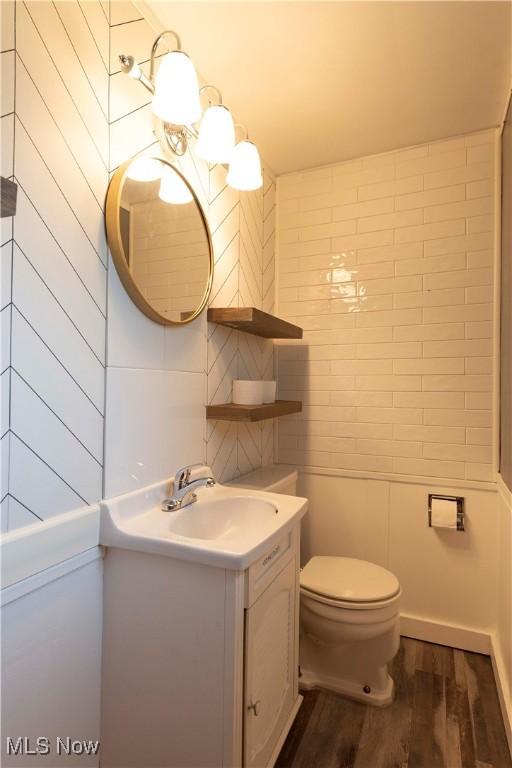 338 Applegrove St NE, North Canton, OH 44720 - bathroom featuring wood finished floors, toilet, and vanity