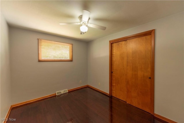 338 Applegrove St NE, North Canton, OH 44720 - unfurnished bedroom with wood finished floors, a closet, baseboards, and ceiling fan