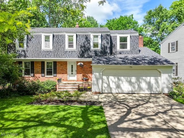 139 Elm Ct, Chagrin Falls, OH 44022 - view of front facade with a chimney, roof with shingles, a front lawn, and driveway