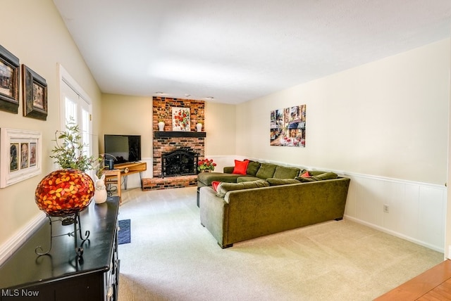 139 Elm Ct, Chagrin Falls, OH 44022 - carpeted living room featuring a brick fireplace, a wainscoted wall, and wood finished floors