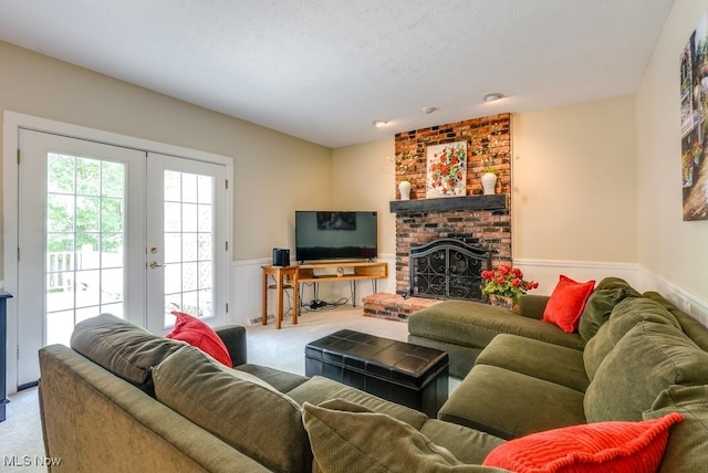 139 Elm Ct, Chagrin Falls, OH 44022 - living room with carpet, wainscoting, a fireplace, and french doors