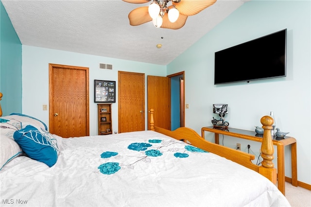 104 Joshua Dr, Rittman, OH 44270 - bedroom with carpet flooring, multiple closets, ceiling fan, a textured ceiling, and baseboards