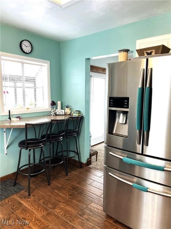 2024 W 10th St, Ashtabula, OH 44004 - kitchen with stainless steel fridge with ice dispenser, healthy amount of natural light, and a breakfast bar area