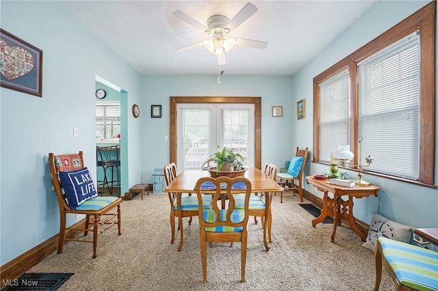 2024 W 10th St, Ashtabula, OH 44004 - dining area with plenty of natural light, light carpet, ceiling fan, and baseboards