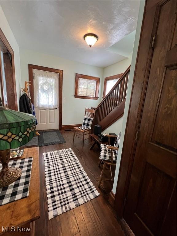 2024 W 10th St, Ashtabula, OH 44004 - foyer entrance with wood finished floors, stairway, and baseboards