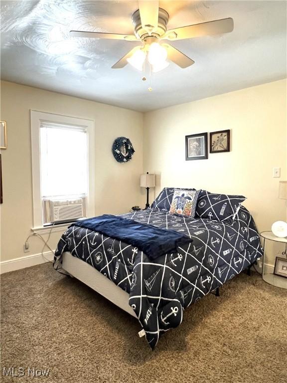 2024 W 10th St, Ashtabula, OH 44004 - carpeted bedroom featuring cooling unit, baseboards, and a ceiling fan