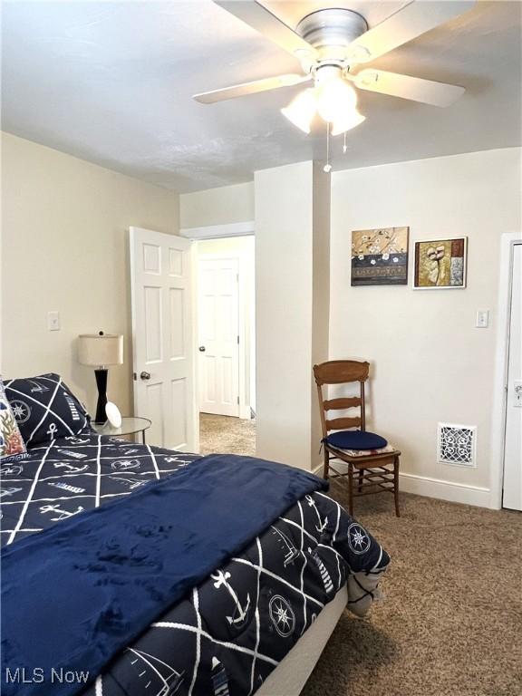 2024 W 10th St, Ashtabula, OH 44004 - bedroom with carpet floors, baseboards, and a ceiling fan