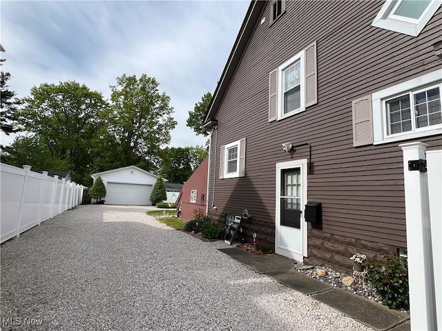 2024 W 10th St, Ashtabula, OH 44004 - view of side of home with a garage and an outdoor structure
