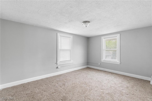 1210 17th St NE, Canton, OH 44705 - carpeted empty room featuring baseboards and a textured ceiling