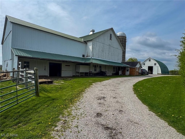 16321 Burton Windsor Rd, Middlefield, OH 44062 - view of side of home with an outdoor structure, metal roof, and gravel driveway