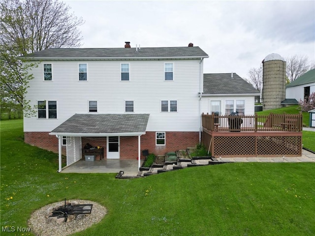 16321 Burton Windsor Rd, Middlefield, OH 44062 - back of property featuring a patio, a yard, a deck, and brick siding