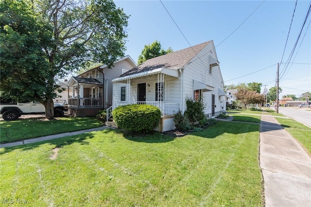125 E 30th St, Lorain, OH 44055 - bungalow with a porch, a front yard, and a shingled roof