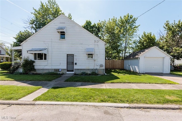 125 E 30th St, Lorain, OH 44055 - bungalow-style house with a detached garage, an outbuilding, and concrete driveway