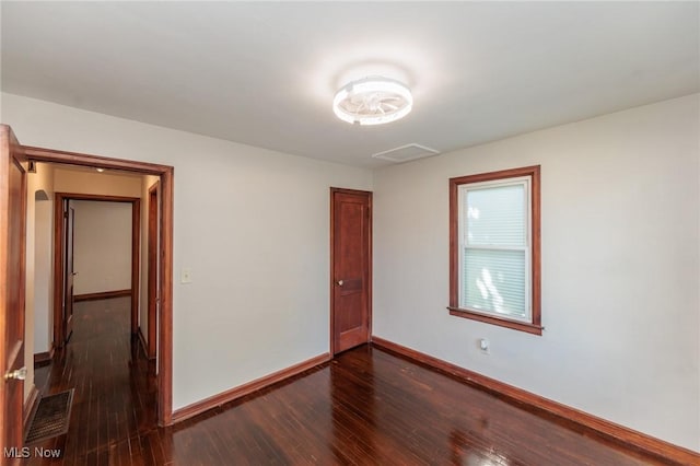 125 E 30th St, Lorain, OH 44055 - unfurnished room featuring dark wood-style flooring, baseboards, and arched walkways