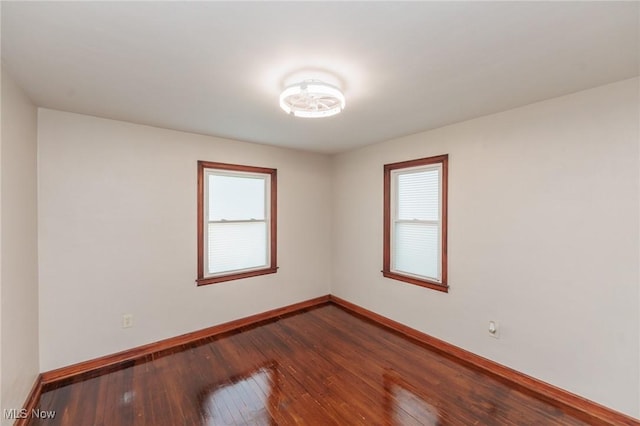 125 E 30th St, Lorain, OH 44055 - unfurnished room with baseboards, dark wood-style flooring, and plenty of natural light