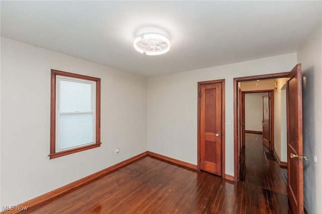 125 E 30th St, Lorain, OH 44055 - empty room featuring dark wood-type flooring and baseboards