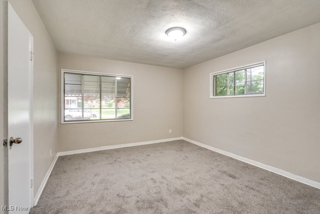 563 Sycamore Dr, Euclid, OH 44132 - unfurnished room featuring a textured ceiling, carpet, and baseboards