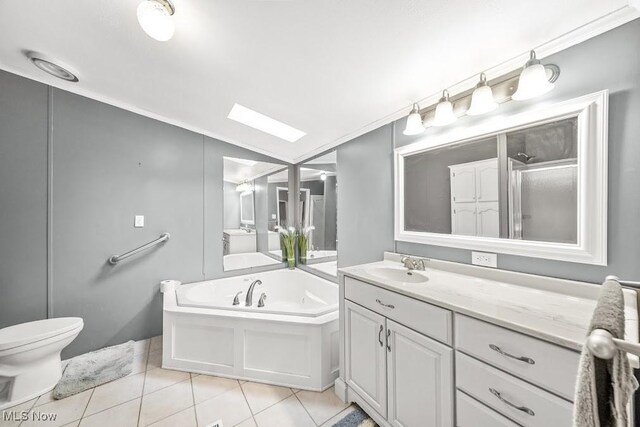 10597 State Route 82, Windham, OH 44288 - bathroom with tile patterned floors, a garden tub, vanity, a stall shower, and toilet