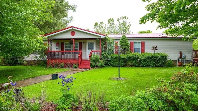 10597 State Route 82, Windham, OH 44288 - view of front of house with covered porch, a front yard, and metal roof