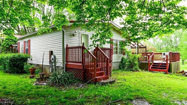 10597 State Route 82, Windham, OH 44288 - view of grassy yard with a wooden deck