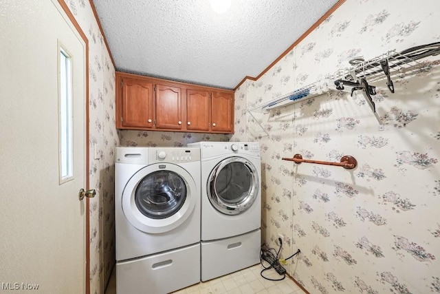 10597 State Route 82, Windham, OH 44288 - washroom featuring wallpapered walls, washer and clothes dryer, a textured ceiling, cabinet space, and crown molding