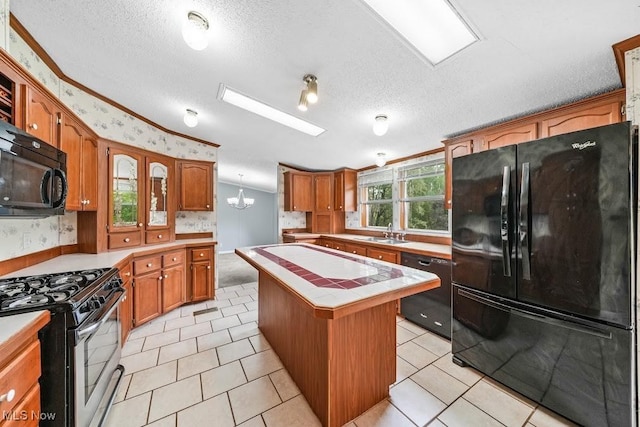 10597 State Route 82, Windham, OH 44288 - kitchen featuring black appliances, tile counters, a center island, a sink, and brown cabinetry